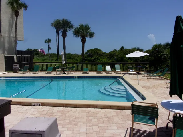 a view of a roof deck with wooden floor and bench