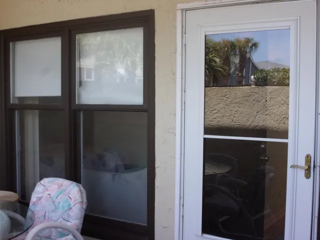 a view of a glass door and a window