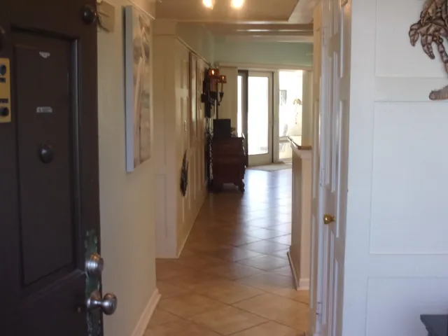 a view of a hallway with a wooden floor