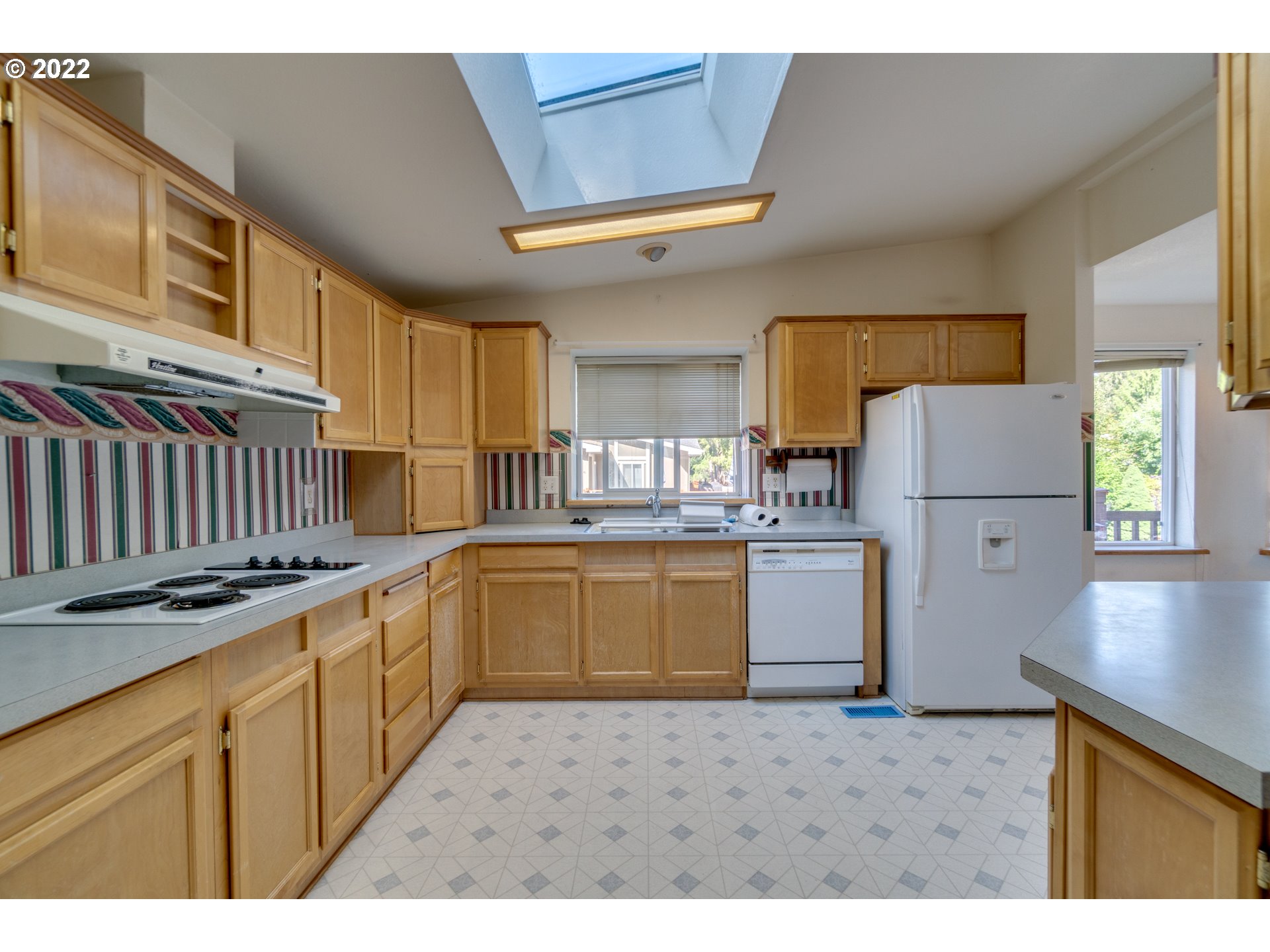 25222 East Welches Road Welches, OR 97067 - Photo 14 of 31 a kitchen with granite countertop a refrigerator stove top oven and cabinets