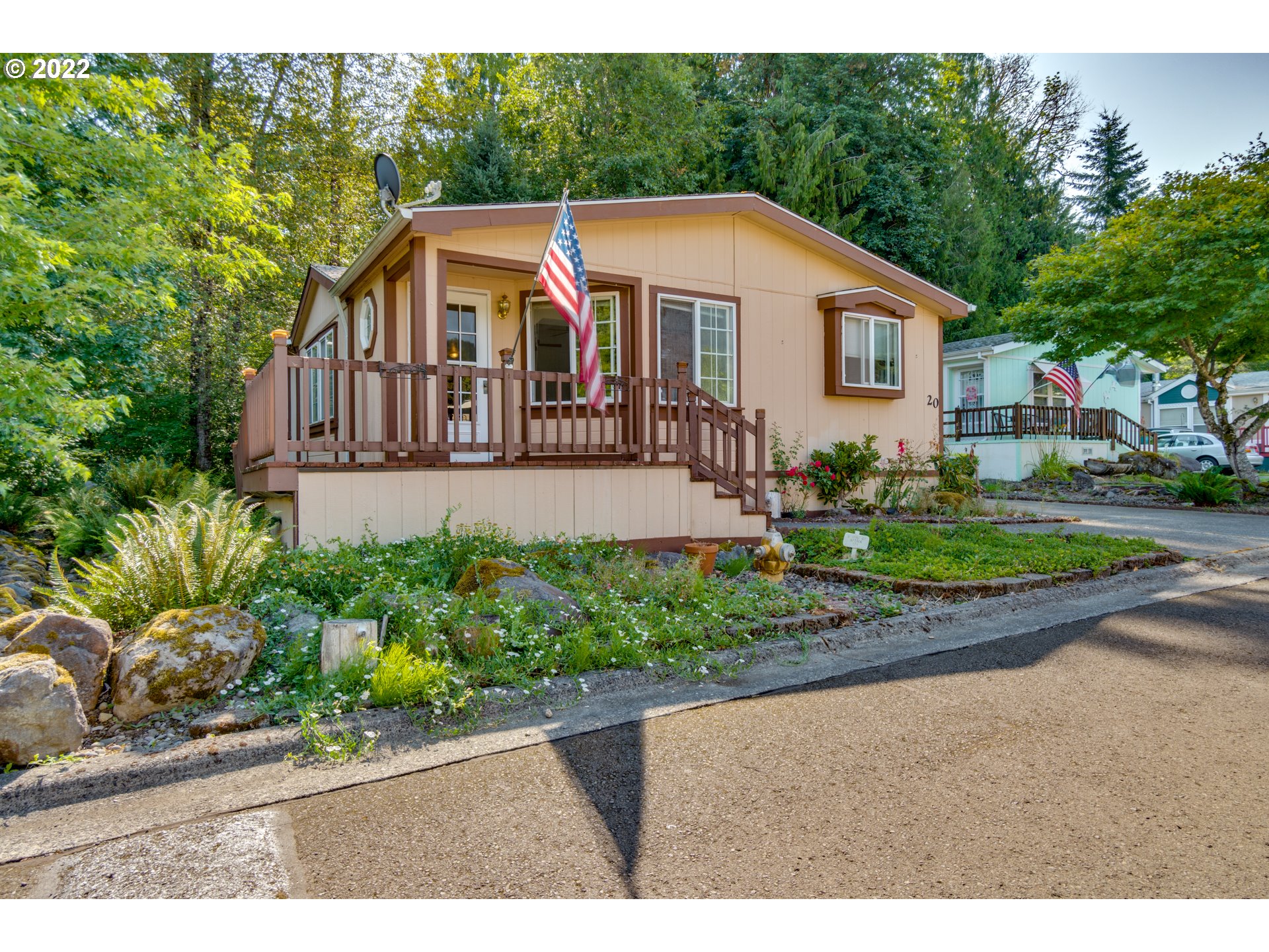 25222 East Welches Road Welches, OR 97067 - Photo 3 of 31 a front view of a house with a yard and potted plants
