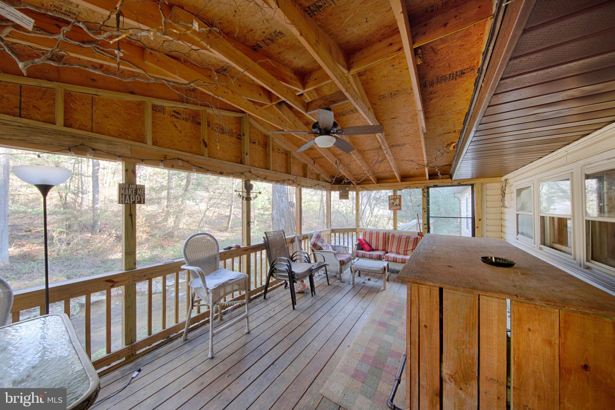 1014 Aubel Road Delta, PA 17314 - Photo 7 of 32 SCREENED REAR PORCH WITH CREEK AND WOODS VIEW !!