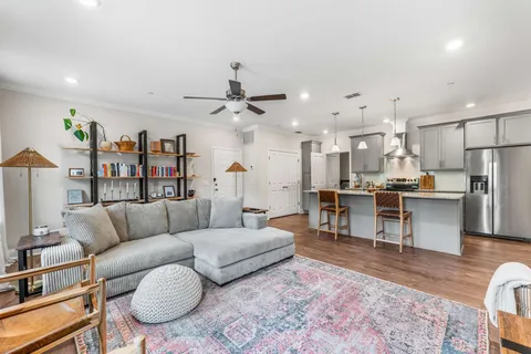 a living room with furniture kitchen view and a dining table