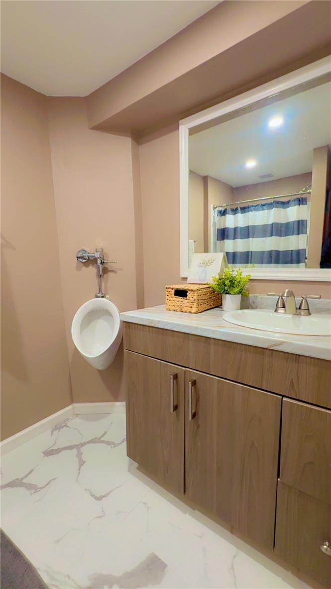 1844 29th Street Southwest Allentown, PA 18103 - Photo 28 of 37 Polished stone counters and clean marble-patterned flooring elevate this functional bathroom space.