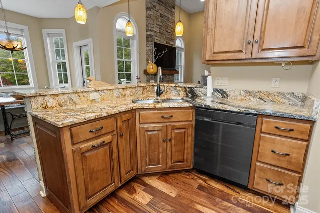 a bathroom with a granite countertop double vanity sink and a mirror