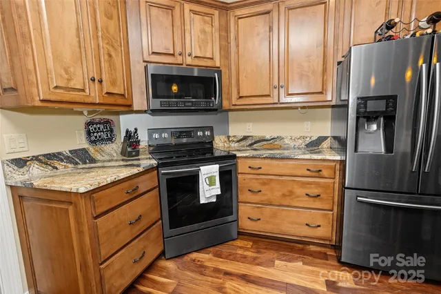 a bathroom with a granite countertop sink and mirror