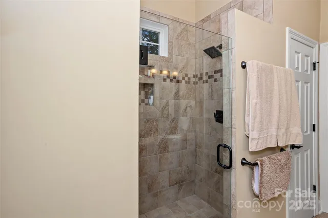 a living room with furniture a fireplace and a chandelier
