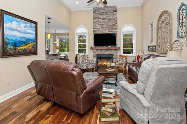 a living room with furniture a flat screen tv and a fireplace