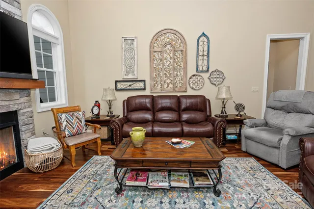 a dining room with furniture a chandelier and wooden floor
