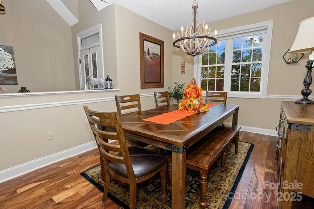 a bedroom with a bed a flat screen tv and a large window