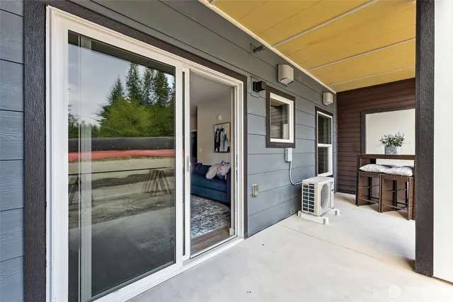 a porch with a table and chairs