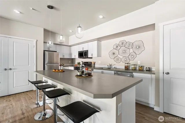 a kitchen with sink cabinets and dining table