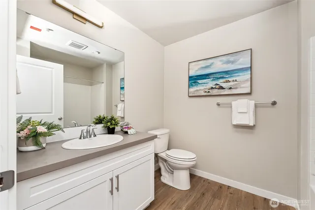 a bathroom with a sink mirror and toilet