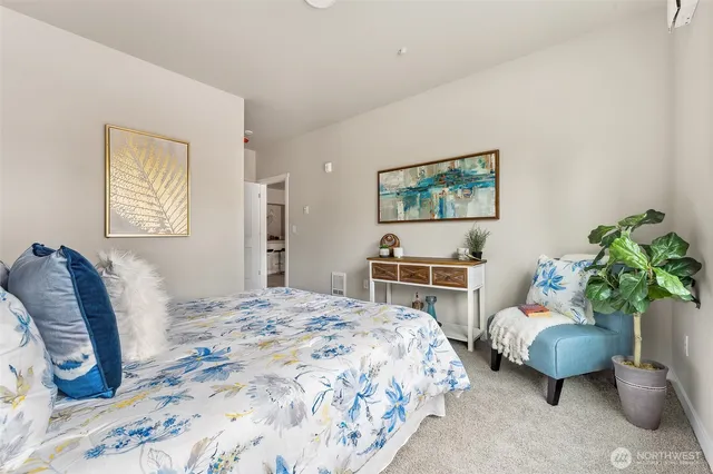 a bedroom with a bed potted plant and a couch