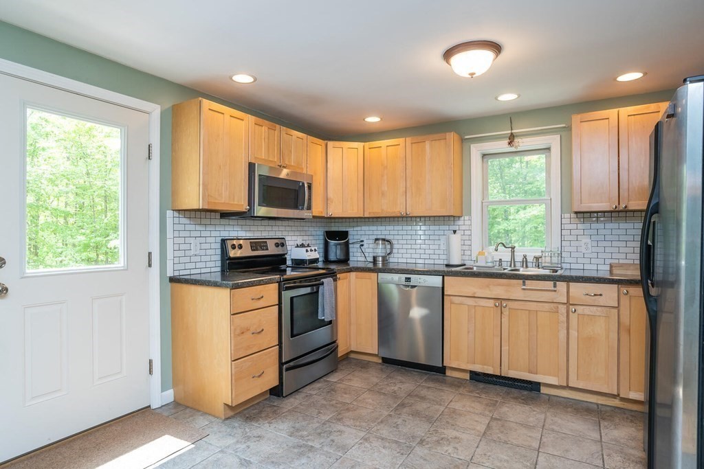 4 Highland Road Williamsburg, MA 01096 - Photo 13 of 42 a kitchen with stainless steel appliances granite countertop a stove a sink and a microwave