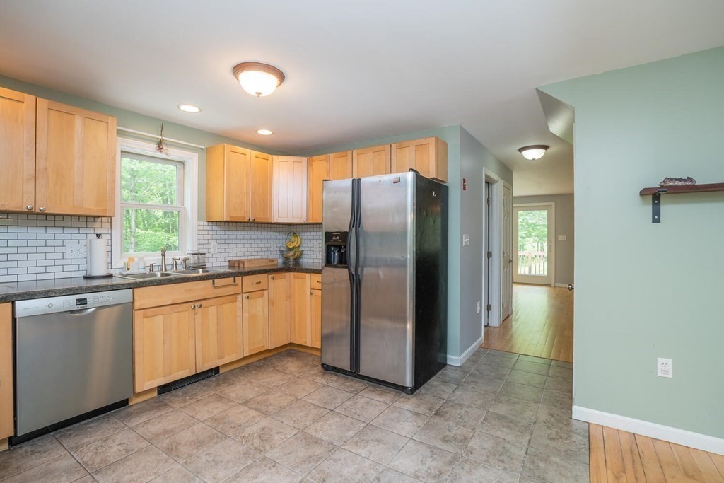 4 Highland Road Williamsburg, MA 01096 - Photo 14 of 42 a kitchen with stainless steel appliances granite countertop a refrigerator and a sink