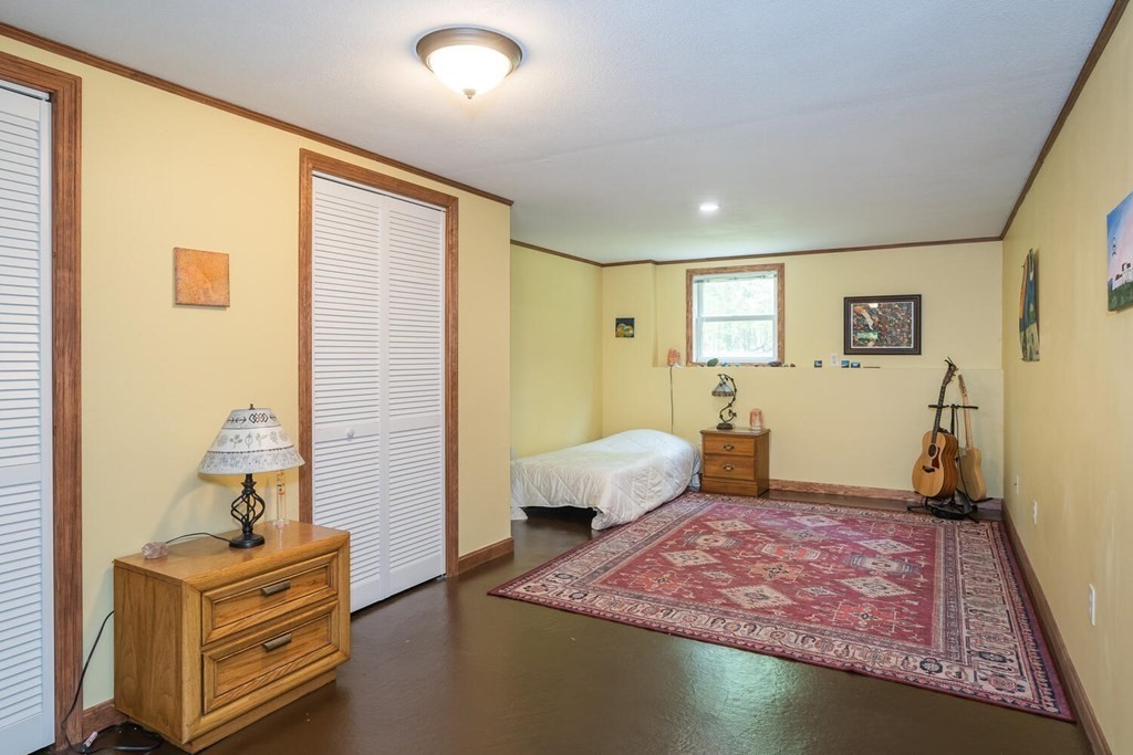 4 Highland Road Williamsburg, MA 01096 - Photo 30 of 42 a bedroom with a bed and wooden floor