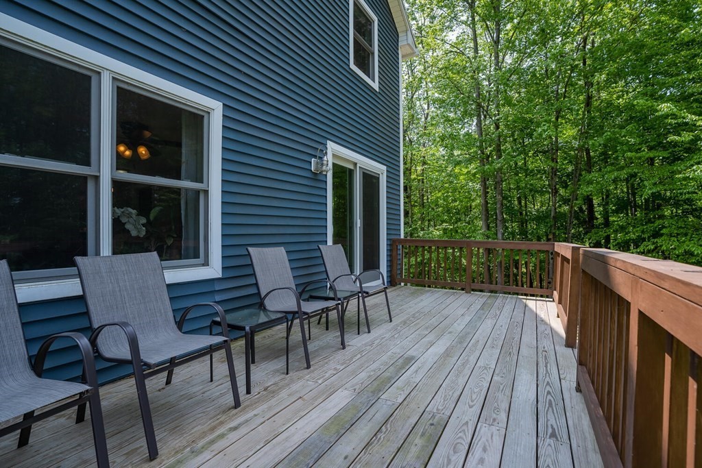 4 Highland Road Williamsburg, MA 01096 - Photo 33 of 42 a view of deck with table and chairs and wooden floor
