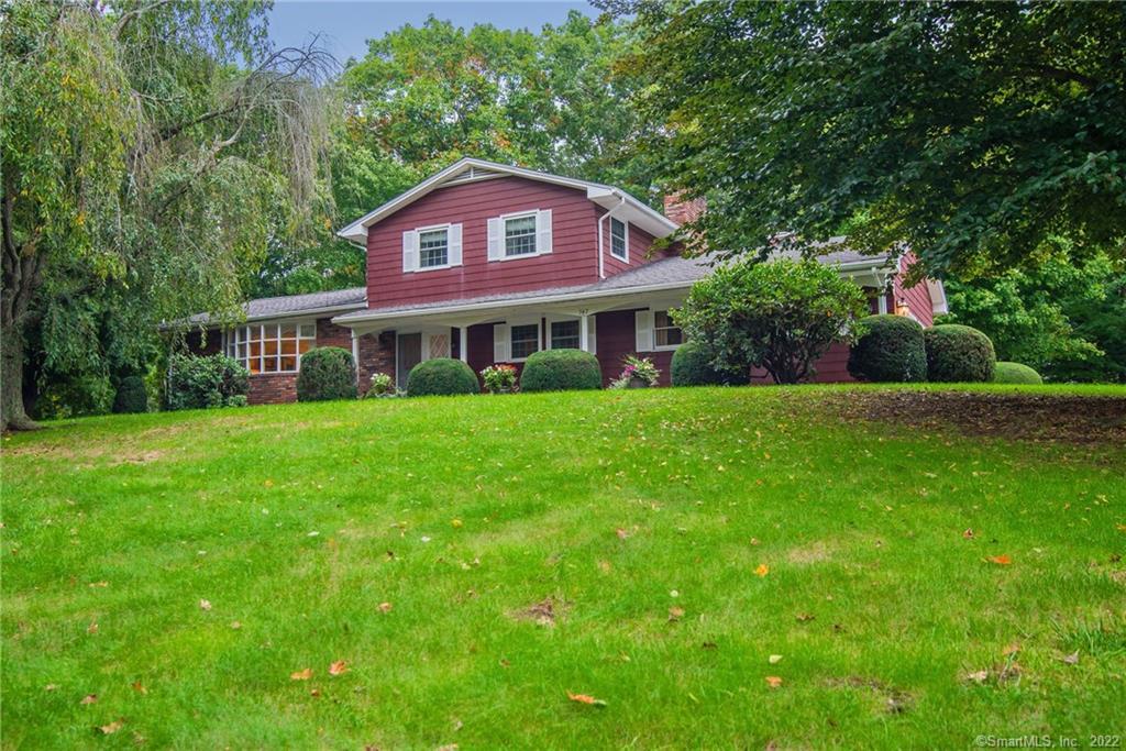 342 Wauregan Road Killingly, CT 06239 - Photo 1 of 1 Front of house with long gently sloping hill with grass and planted trees almost hidden from Wauregan Rd.