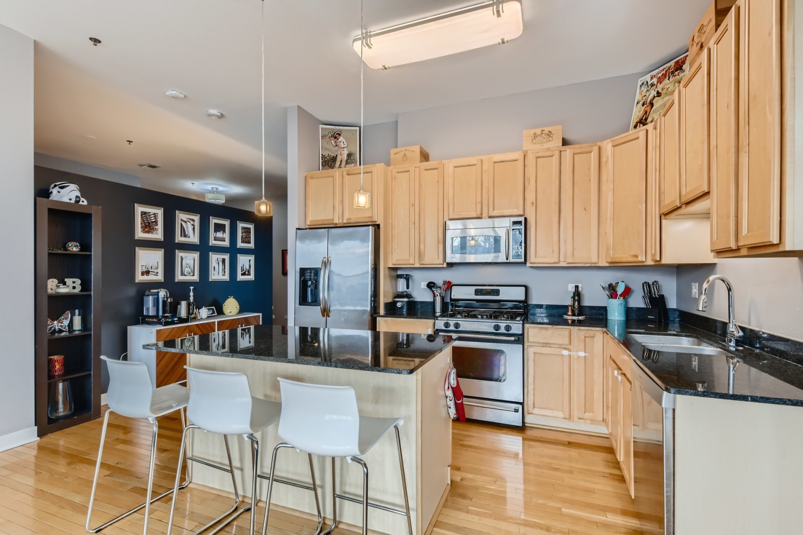 1 South Leavitt Street, Unit 307 Chicago, IL 60612 - Photo 11 of 23 a kitchen with stainless steel appliances granite countertop a stove top oven a sink a dining table and chairs