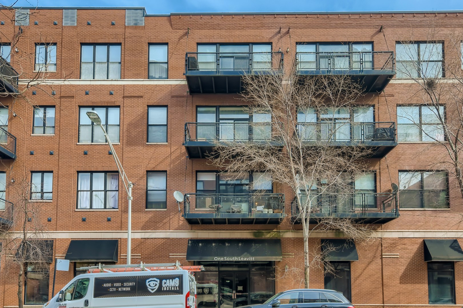 1 South Leavitt Street, Unit 307 Chicago, IL 60612 - Photo 2 of 23 a front view of a building with a lot of windows
