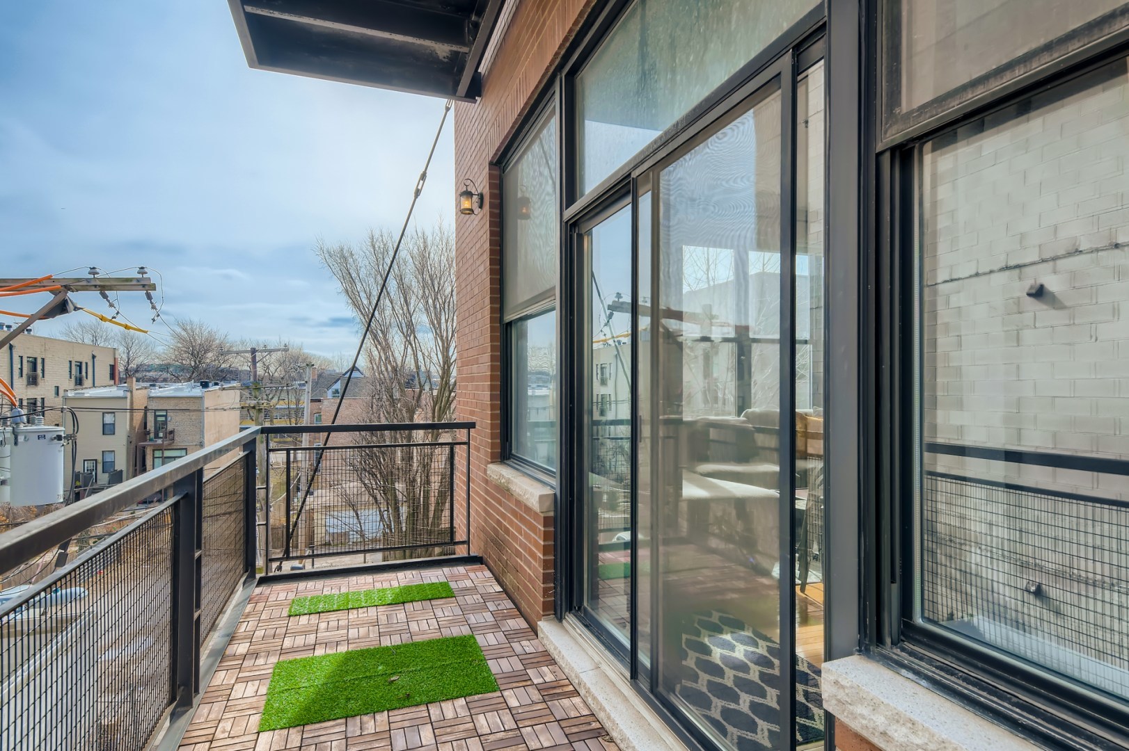 1 South Leavitt Street, Unit 307 Chicago, IL 60612 - Photo 21 of 23 a view of a balcony with a potted plant