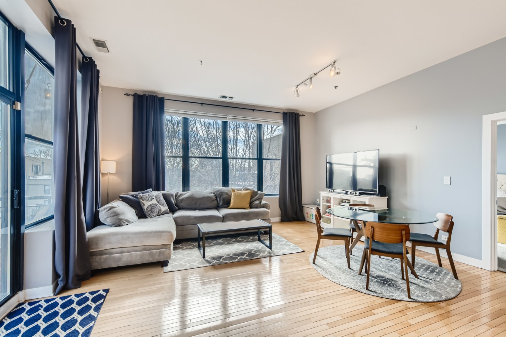 1 South Leavitt Street, Unit 307 Chicago, IL 60612 - Photo 7 of 23 a living room with furniture and a window