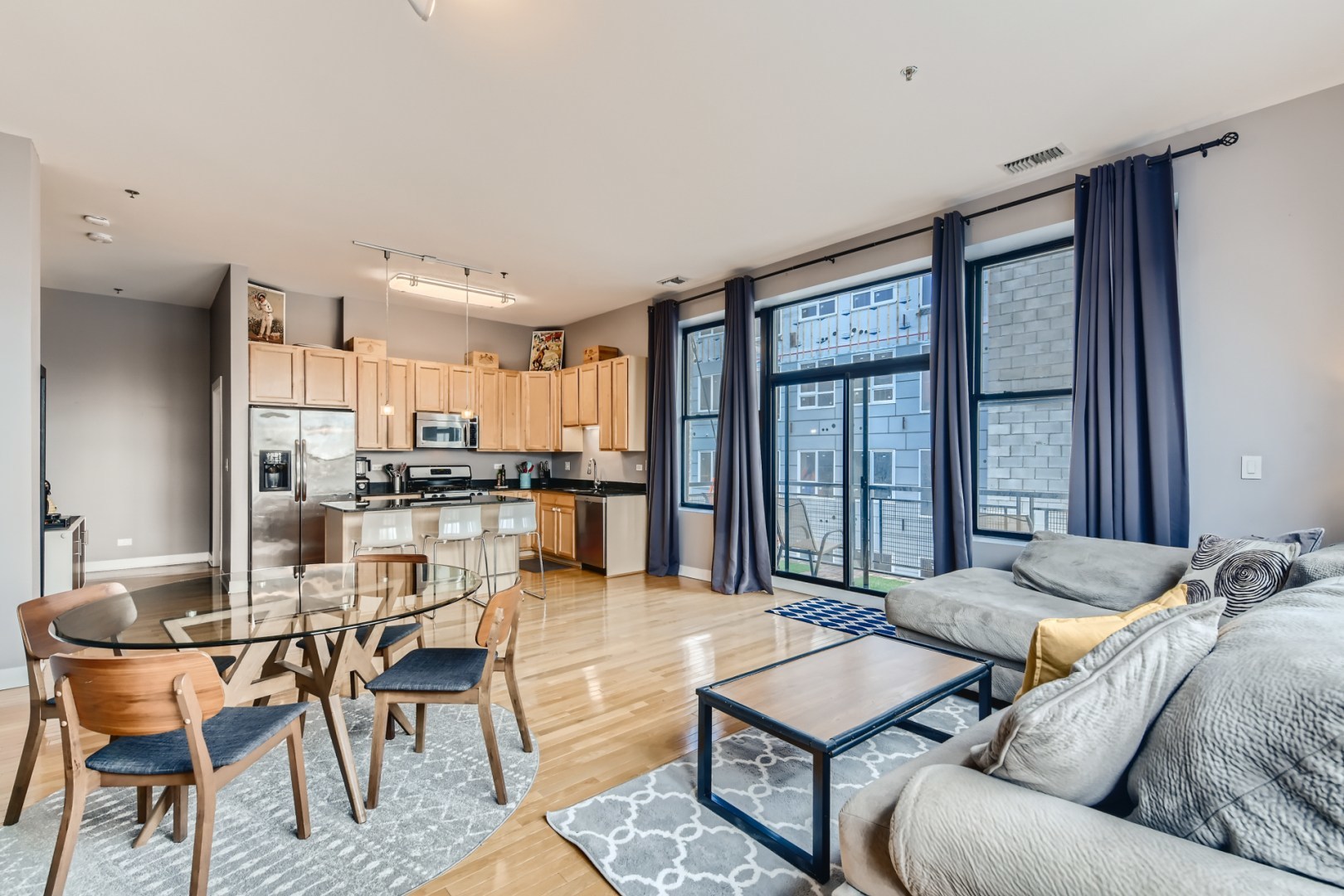 1 South Leavitt Street, Unit 307 Chicago, IL 60612 - Photo 8 of 23 a living room with furniture and a large window