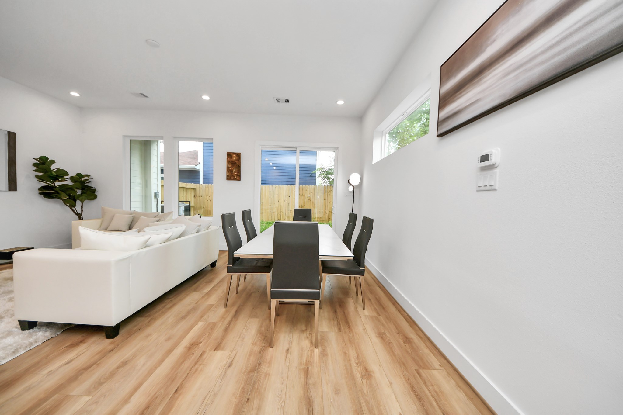 507 Middle Street Houston, TX 77003 - Photo 11 of 48 Discover a bright and modern dining area seamlessly connected to the living space, featuring sleek flooring, contemporary design, and abundant natural light for a perfect blend of style and comfort.