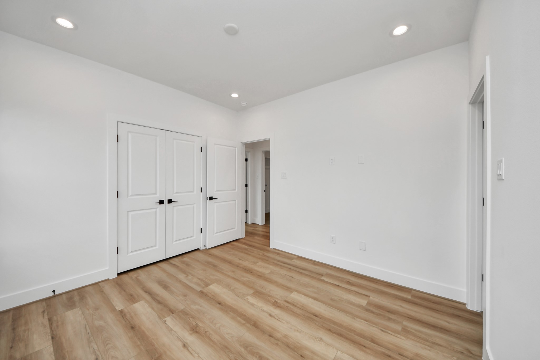 507 Middle Street Houston, TX 77003 - Photo 36 of 48 This inviting third bedroom on the second floor features sleek wood floors, abundant natural light, and ample closet space, perfect for creating a cozy retreat.