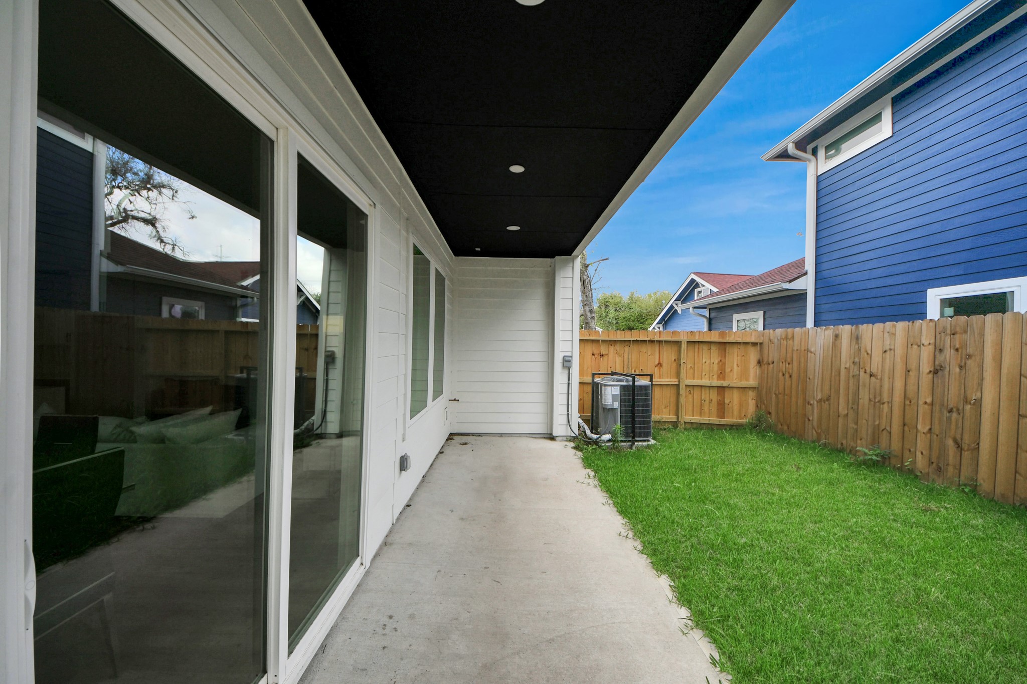 507 Middle Street Houston, TX 77003 - Photo 38 of 48 Discover a cozy backyard retreat featuring a sleek covered patio and lush lawn, perfect for relaxation and outdoor gatherings.