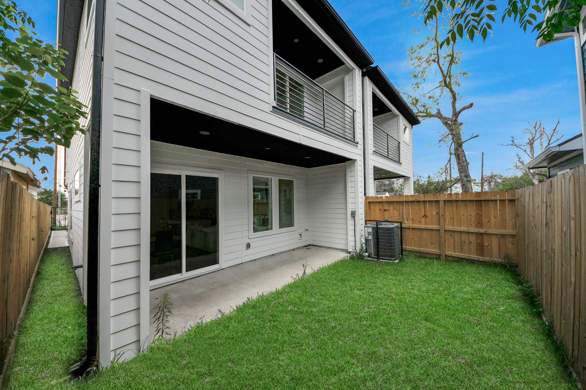 507 Middle Street Houston, TX 77003 - Photo 39 of 48 Discover serene outdoor living in this charming backyard, featuring a lush lawn, a cozy covered patio perfect for relaxation, and a modern, elegant façade that enhances the home's appeal.