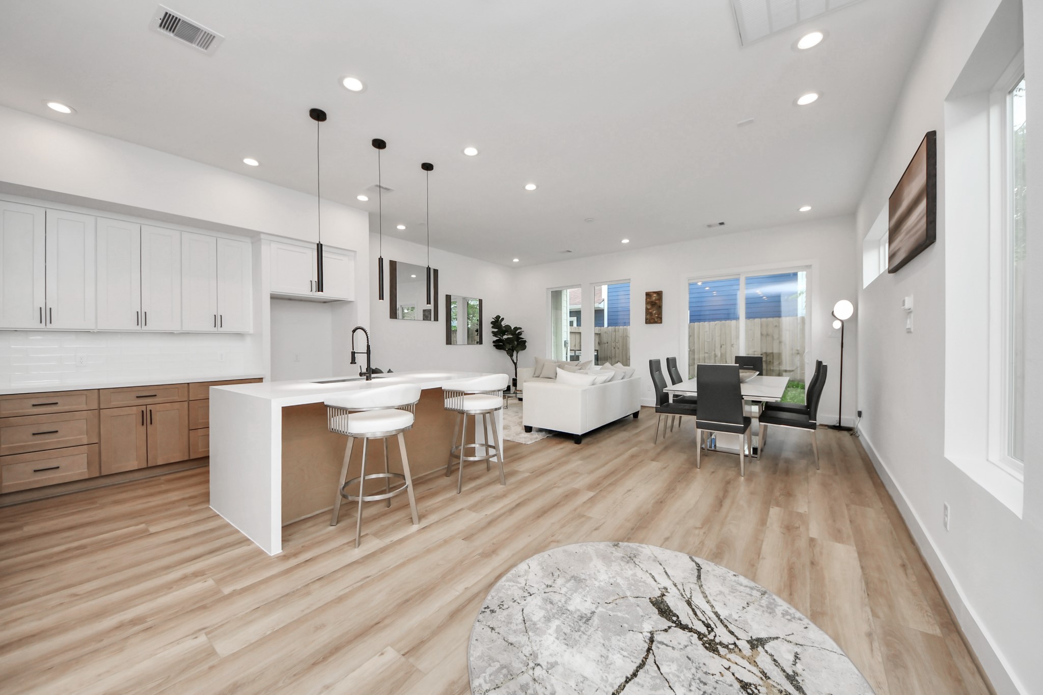 507 Middle Street Houston, TX 77003 - Photo 6 of 48 Discover modern elegance in this open-concept living space, featuring a stunning waterfall kitchen island that seamlessly blends style and functionality.