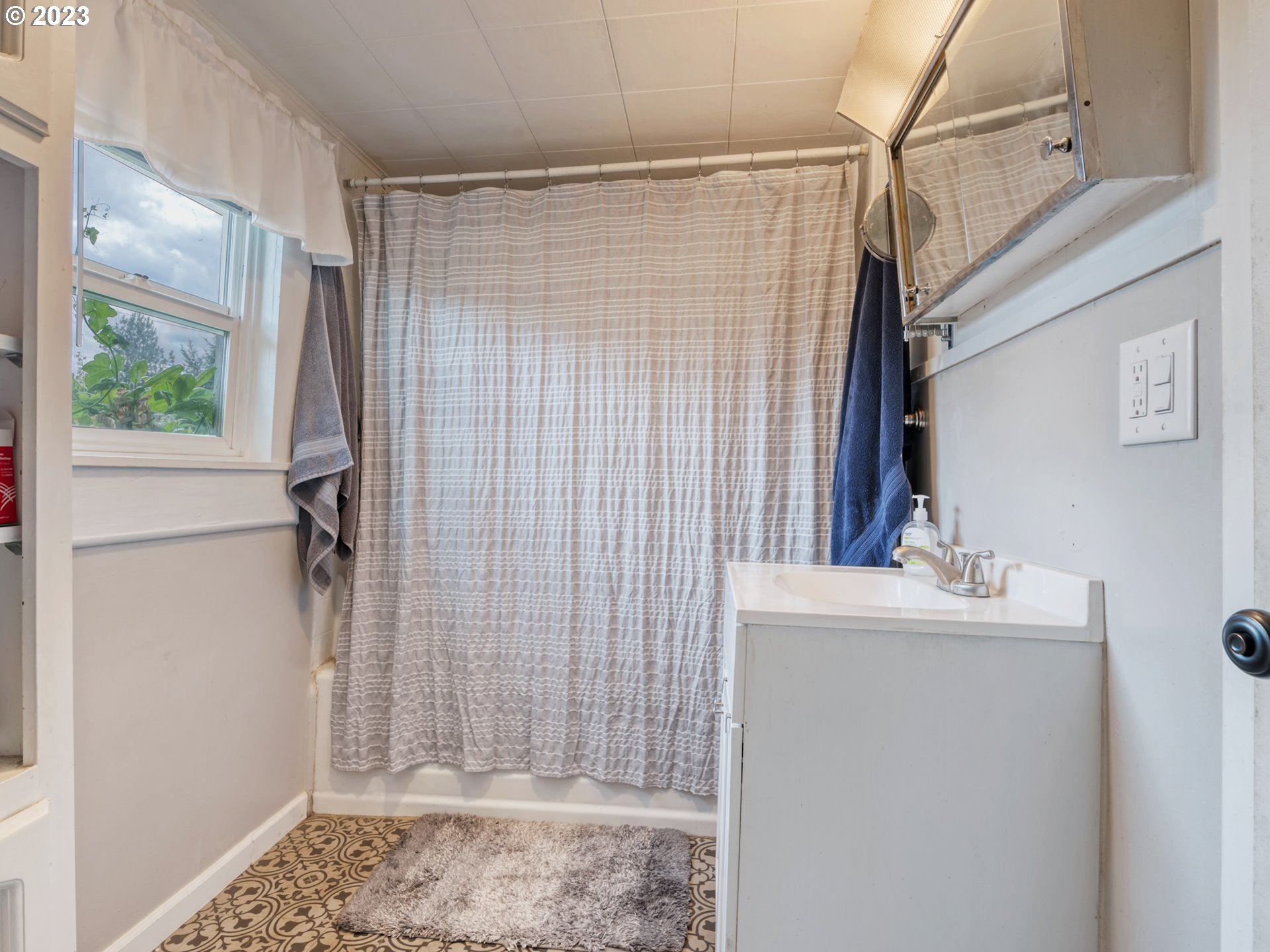2640 Hayden Bridge Road Springfield, OR 97477 - Photo 17 of 46 a bathroom with a sink a mirror and shower