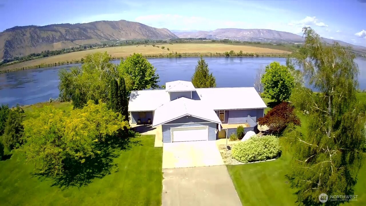32 Midland Road Brewster, WA 98812 - Photo 1 of 40 a view of a lake with a mountain in the background