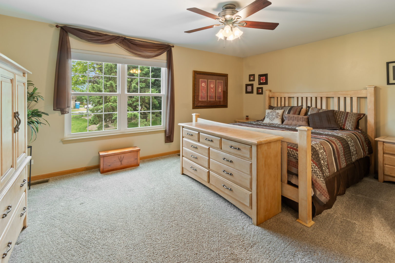 1985 Rochelle Court Wheeling, IL 60090 - Photo 9 of 38 a spacious bedroom with a bed and a chandelier