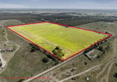 an aerial view of a pool and an ocean