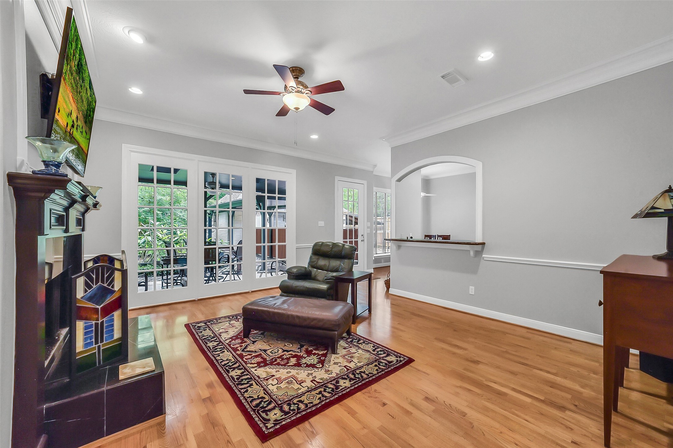1260 Fries Road Houston, TX 77055 - Photo 7 of 42 Cozy Living Room with Timeless Paneled Windows with stunning views into your private oasis of a wooded backyard right in the Heart of Houston!
