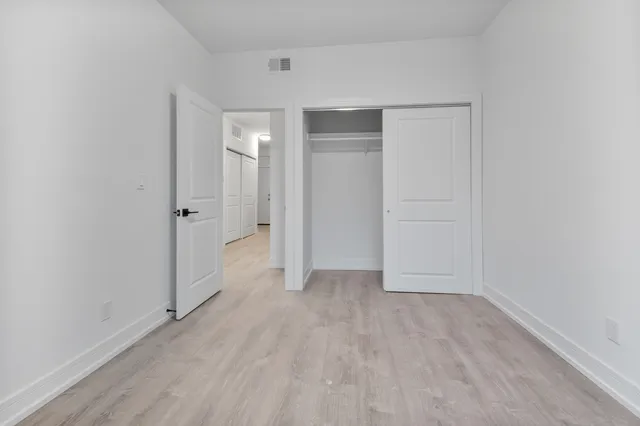 a view of a room with wooden floor