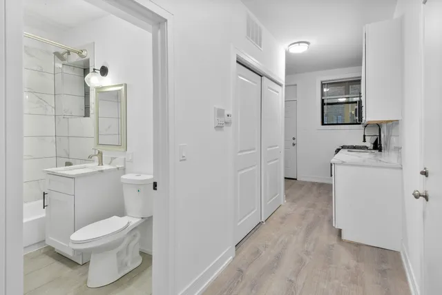 a bathroom with a toilet sink and mirror