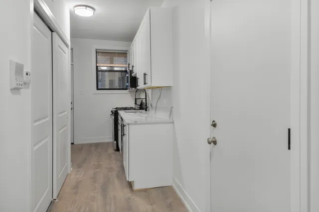 a room with a sink and a mirror