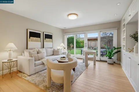 a living room with stainless steel appliances kitchen island granite countertop furniture and a kitchen view