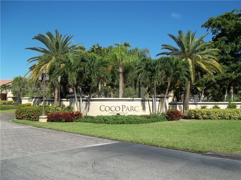 631 Lyons Road, Unit 12205 Coconut Creek, FL 33063 - Photo 14 of 14 a view of garden with tall trees