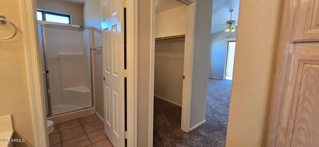 a bathroom with a shower and a glass door