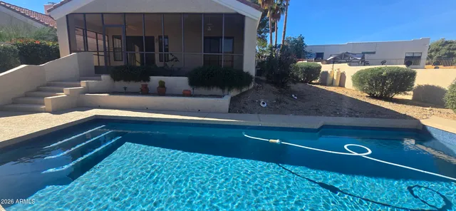 a view of swimming pool with seating space