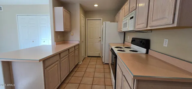 a kitchen with stainless steel appliances a stove a sink and a refrigerator