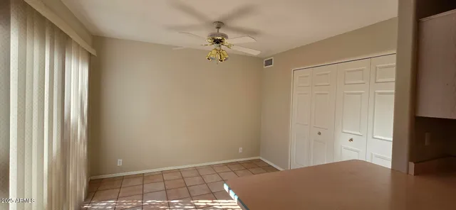 an empty room with windows and closet