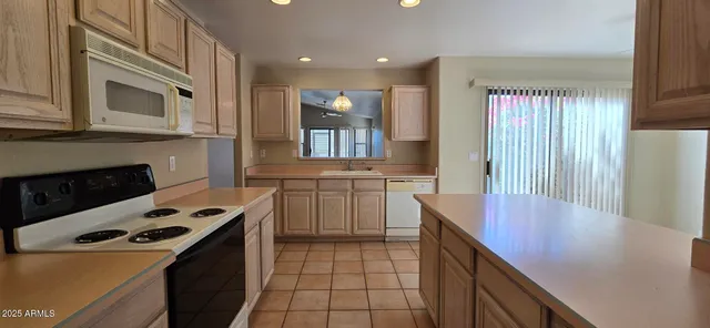 a kitchen with a stove cabinets and a refrigerator