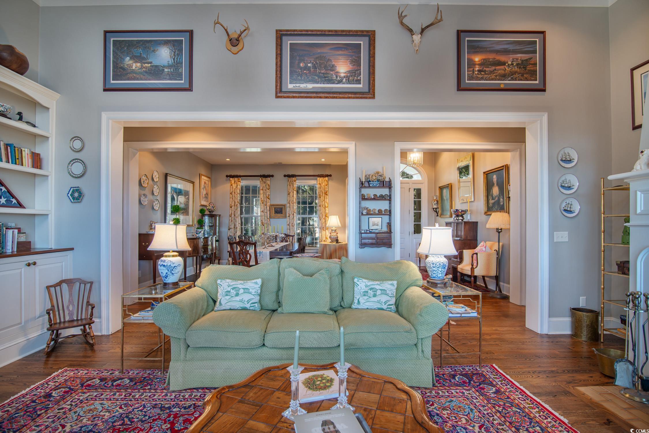 762 Wraggs Ferry Road Georgetown, SC 29440 - Photo 13 of 33 Living room with dark wood-type flooring, a high ceiling, and baseboards