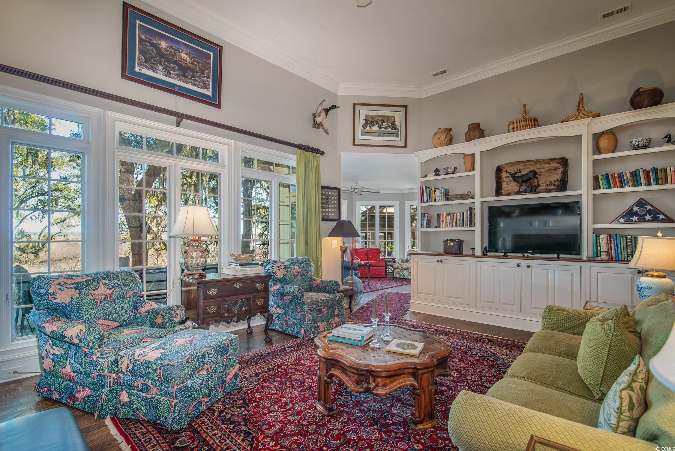 762 Wraggs Ferry Road Georgetown, SC 29440 - Photo 14 of 33 Living area with visible vents, ornamental molding, and wood finished floors